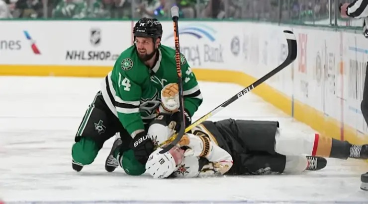 Hockey player checks opponent on ice.